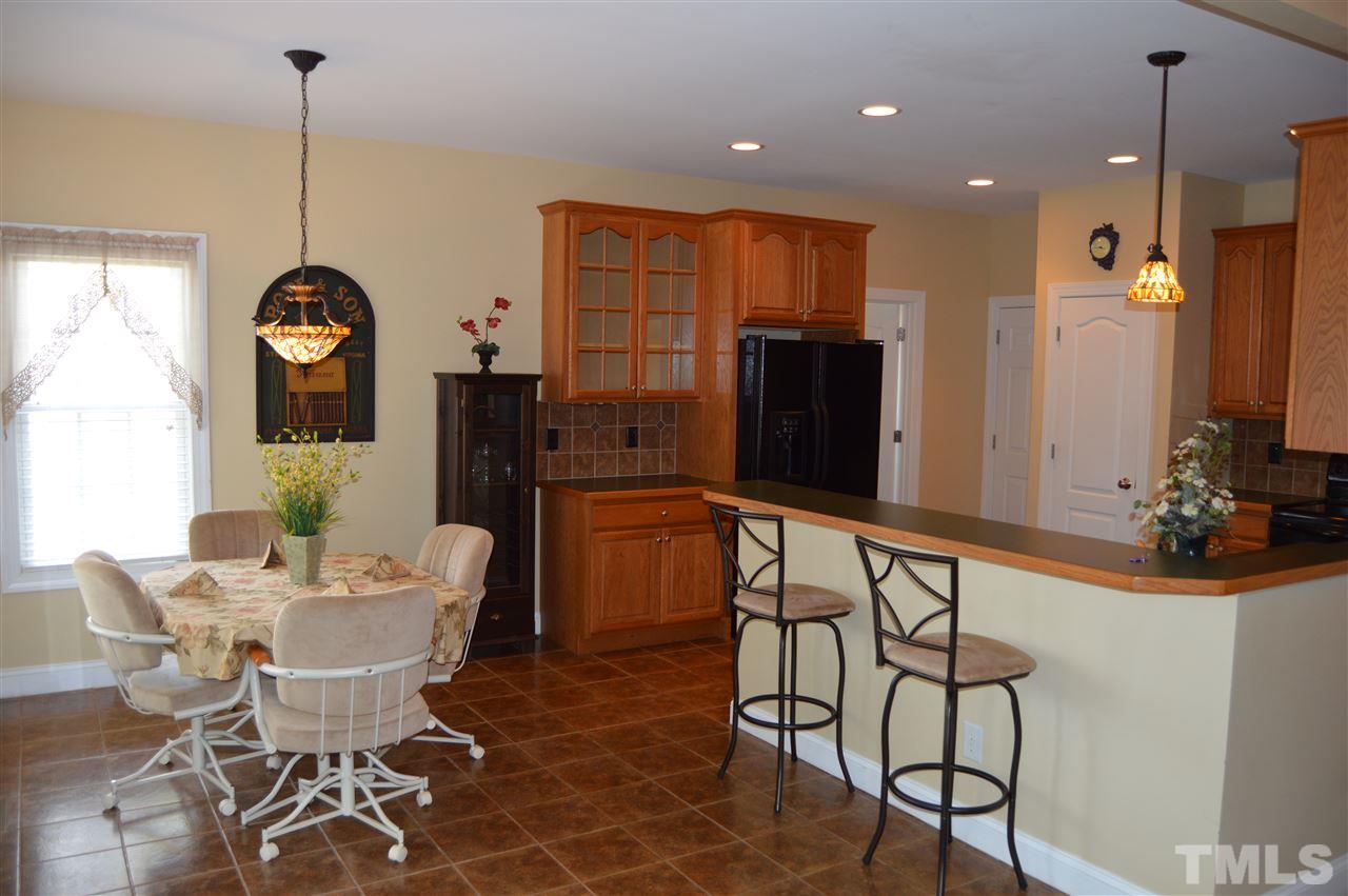 1069 Wheeler Pond Road Creedmoor, NC 27522 - Photo 10 of 22 a view of a dining room with furniture and a chandelier