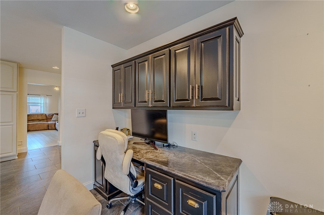 305 South Vandemark Road Sidney, OH 45365 - Photo 15 of 32 This dedicated workspace offers custom cabinetry and durable flooring for productivity.