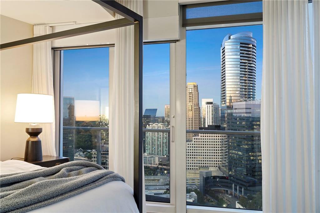 3325 Piedmont Road Northeast, Unit 2804 Atlanta, GA 30305 - Photo 26 of 65 a bedroom with a balcony a bed and a window