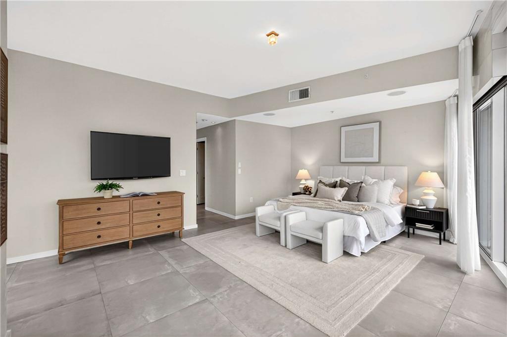 3325 Piedmont Road Northeast, Unit 2804 Atlanta, GA 30305 - Photo 28 of 65 a bed room with furniture and a flat screen tv