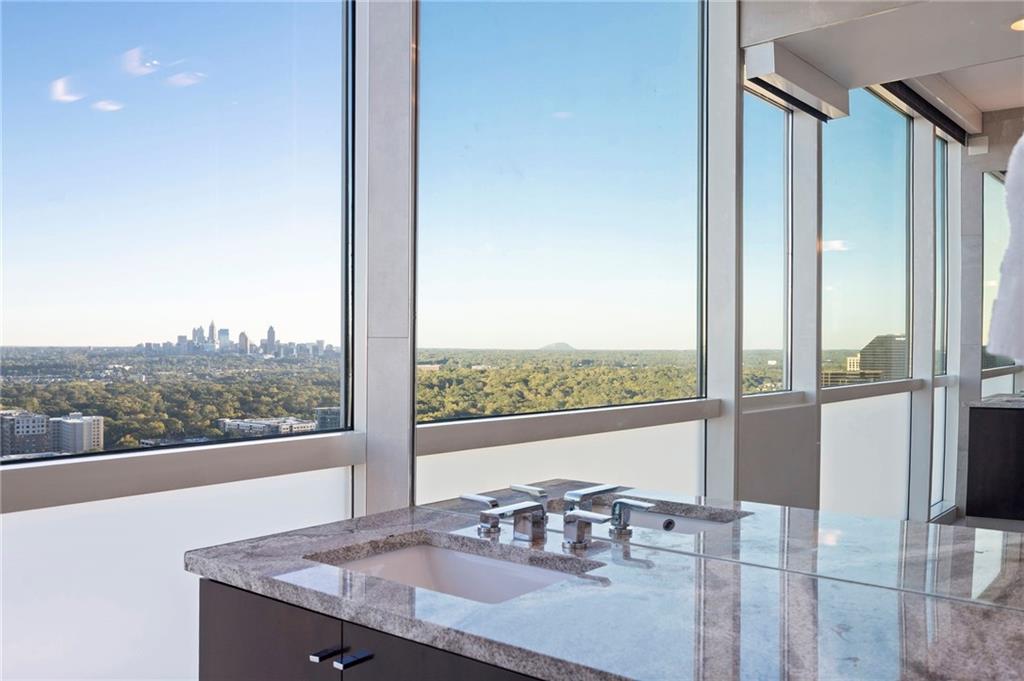 3325 Piedmont Road Northeast, Unit 2804 Atlanta, GA 30305 - Photo 33 of 65 a view of a city from a dining room with a table