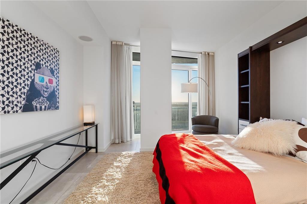 3325 Piedmont Road Northeast, Unit 2804 Atlanta, GA 30305 - Photo 40 of 65 a bedroom with bed and a painting on the wall