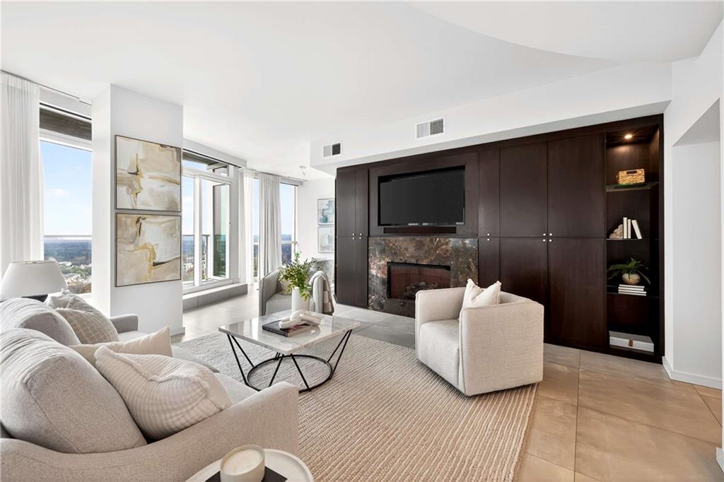 3325 Piedmont Road Northeast, Unit 2804 Atlanta, GA 30305 - Photo 4 of 65 a living room with furniture and a flat screen tv