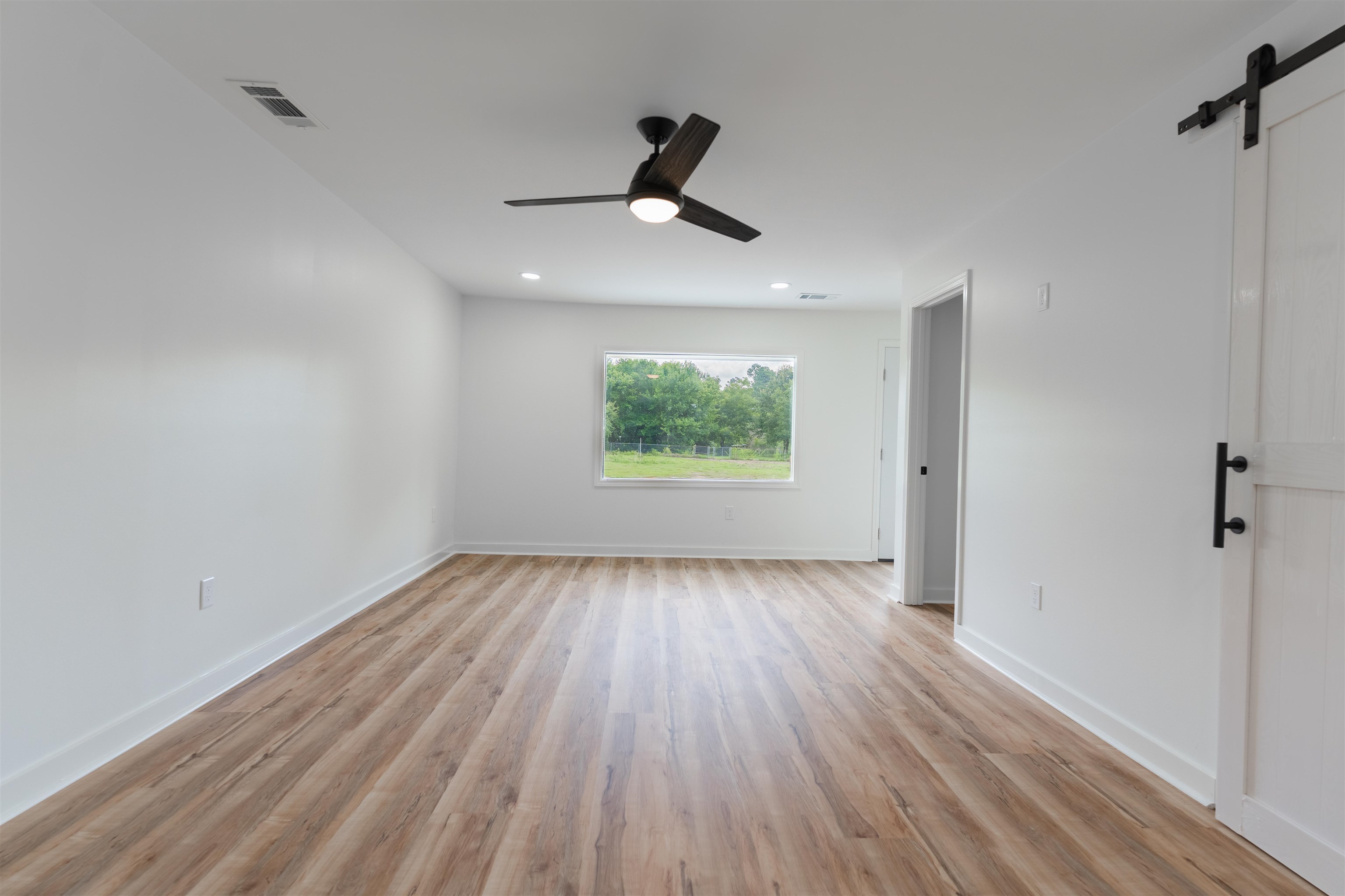815 Fisherville Road Collierville, TN 38017 - Photo 17 of 40 a view of an empty room with wooden floor and a window