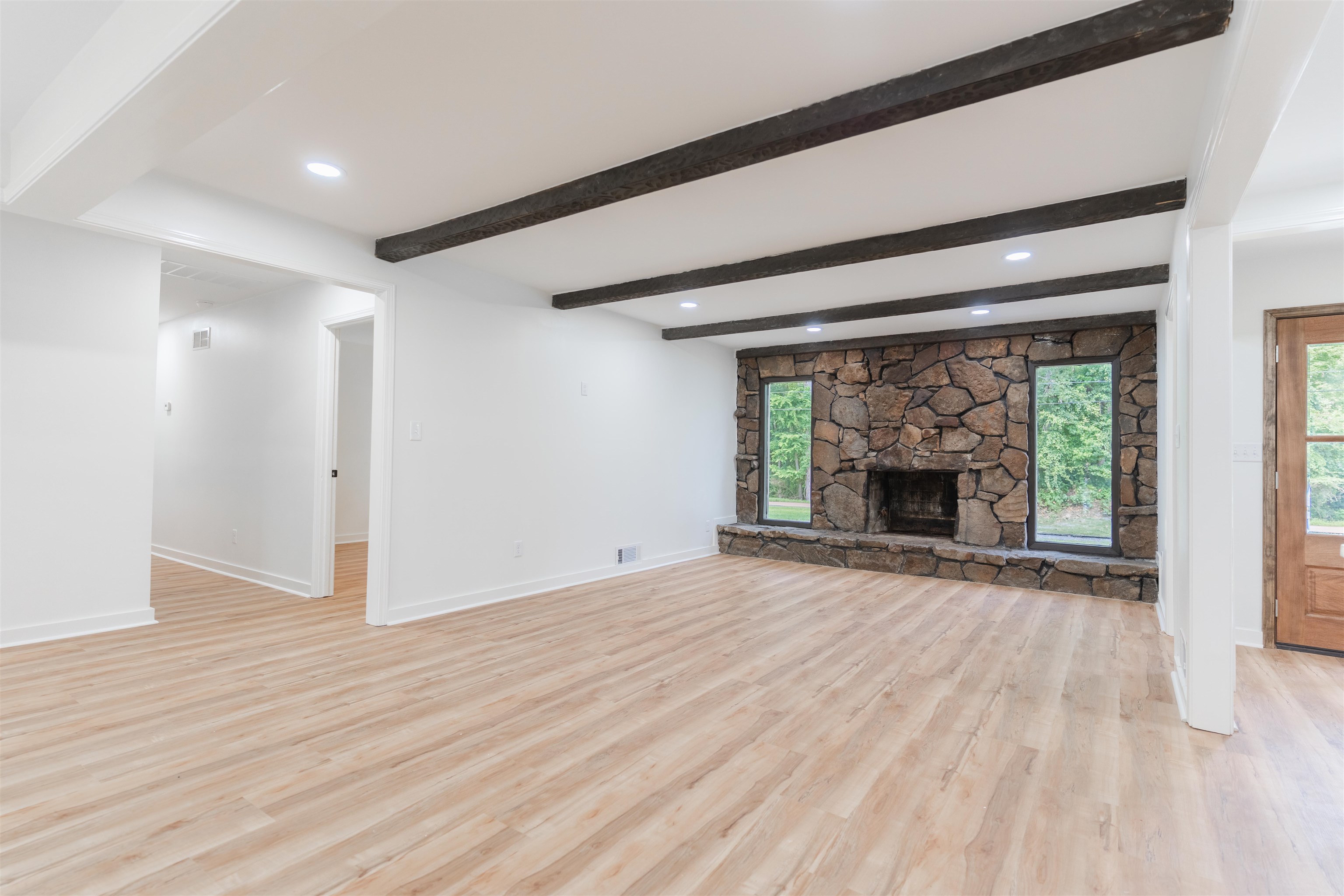 815 Fisherville Road Collierville, TN 38017 - Photo 8 of 40 a view of an empty room with wooden floor fireplace and a window