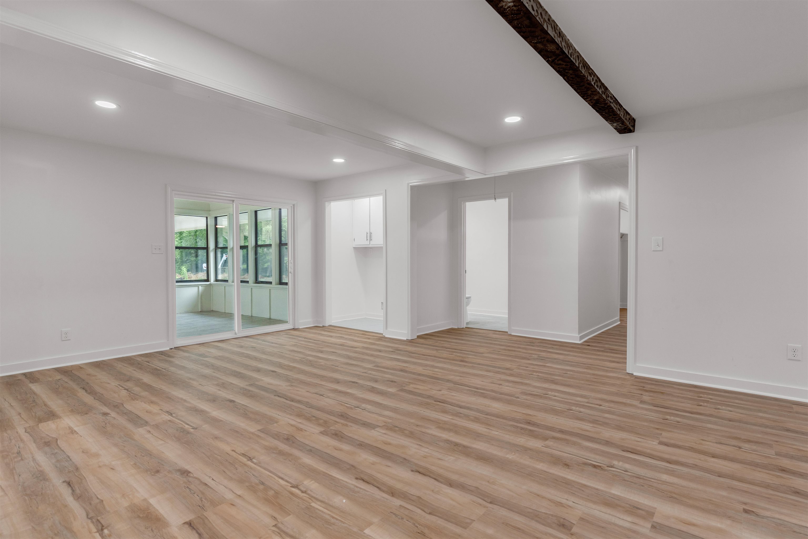 815 Fisherville Road Collierville, TN 38017 - Photo 9 of 40 a view of an empty room with wooden floor and a window