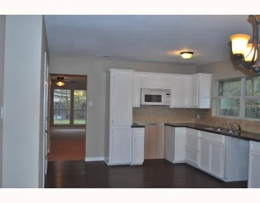 a kitchen with stainless steel appliances granite countertop a sink and cabinets