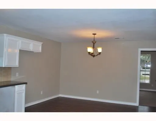 a view of a livingroom with a chandelier fan