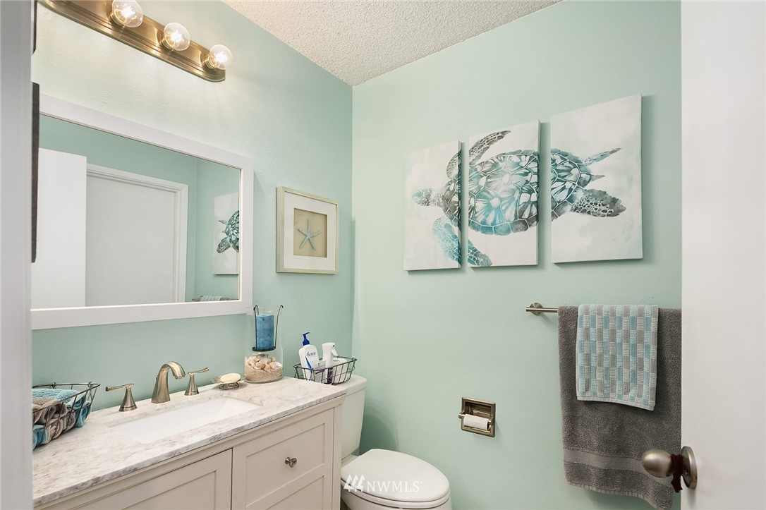 7407 Old Redmond Road, Unit 207 Redmond, WA 98052 - Photo 18 of 23 a bathroom with a toilet a sink and mirror