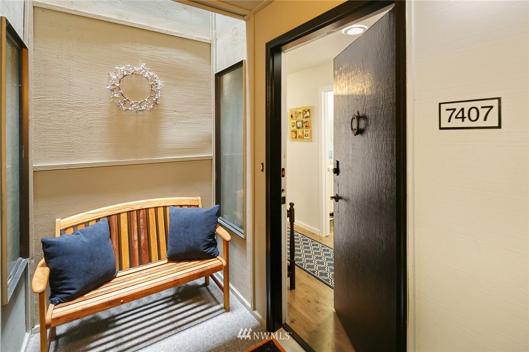 7407 Old Redmond Road, Unit 207 Redmond, WA 98052 - Photo 3 of 23 a view of a hallway with wooden floor and a bathroom
