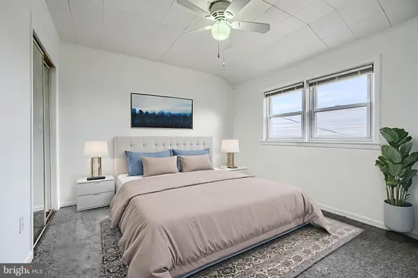 a bedroom with a large bed and a window