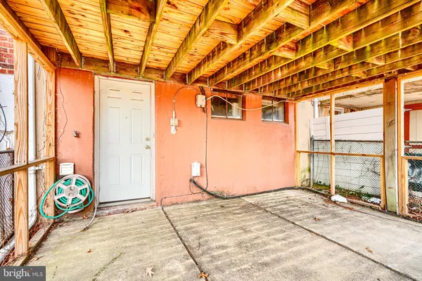 a view of a room with wooden floor and iron stairs