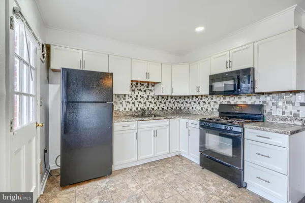 a kitchen with stainless steel appliances granite countertop a refrigerator stove and sink