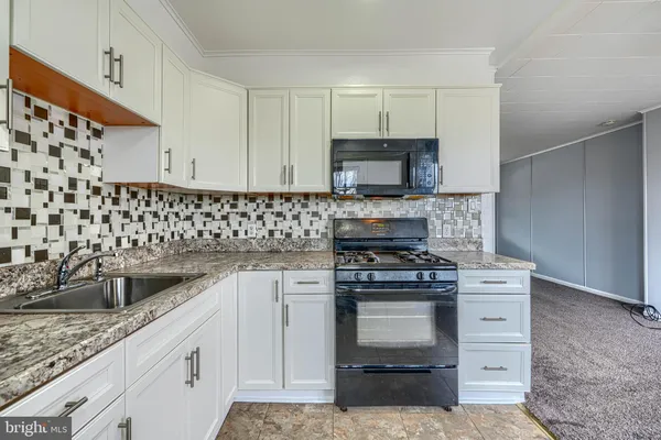a kitchen with a stove and a sink