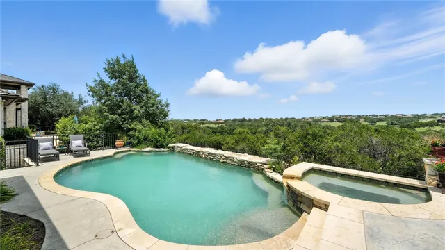 a view of a swimming pool in the back of a house