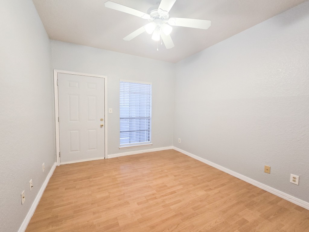 500 Ferry Road, Unit 323C Galveston, TX 77550 - Photo 11 of 17 an empty room with windows and fan