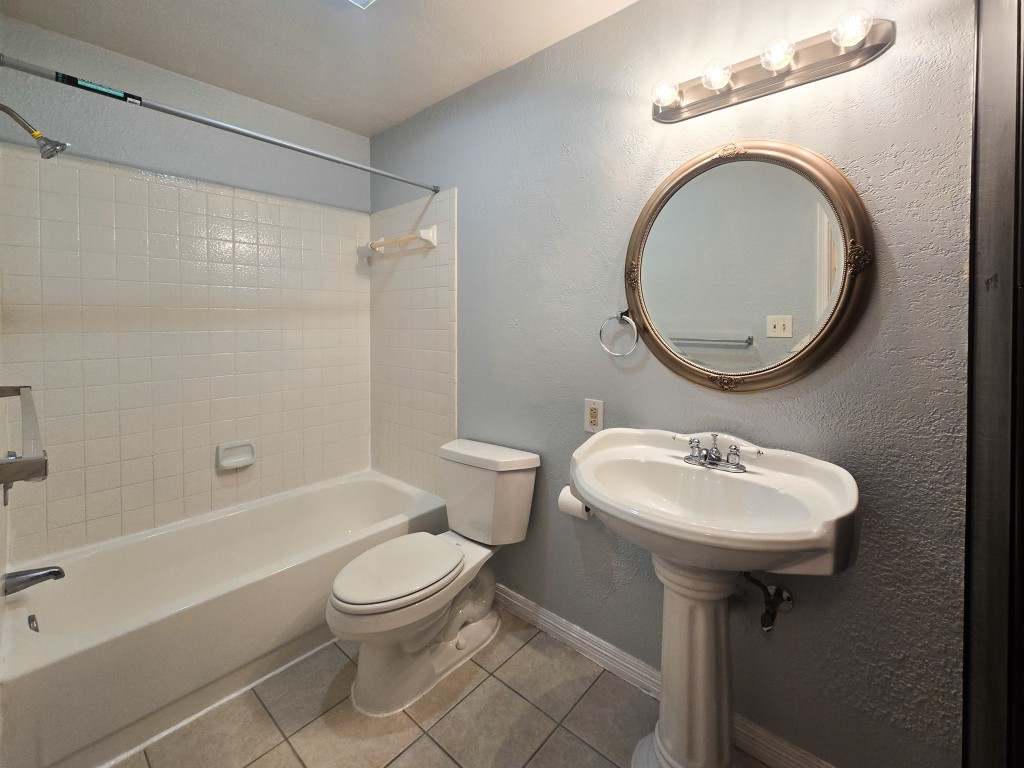 500 Ferry Road, Unit 323C Galveston, TX 77550 - Photo 12 of 17 a bathroom with a sink a toilet and a bathtub