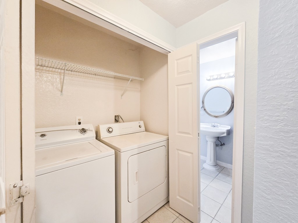 500 Ferry Road, Unit 323C Galveston, TX 77550 - Photo 14 of 17 a utility room with dryer and washer