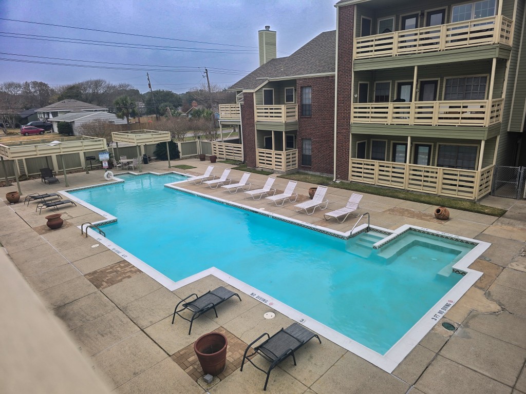 500 Ferry Road, Unit 323C Galveston, TX 77550 - Photo 16 of 17 a view of a house with pool and chairs