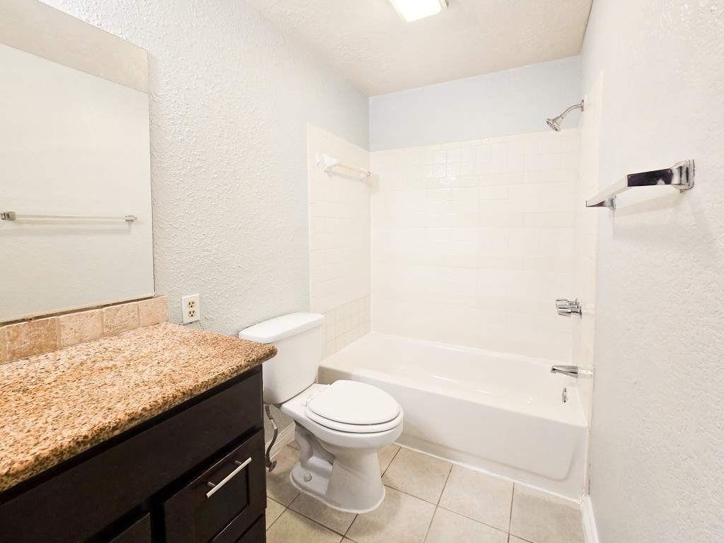 500 Ferry Road, Unit 323C Galveston, TX 77550 - Photo 6 of 17 a bathroom with a granite countertop sink toilet and shower