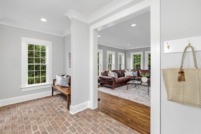 a spacious bedroom with a bed and a lamp