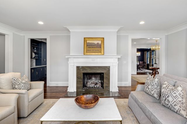 a living room with furniture and floor to ceiling windows