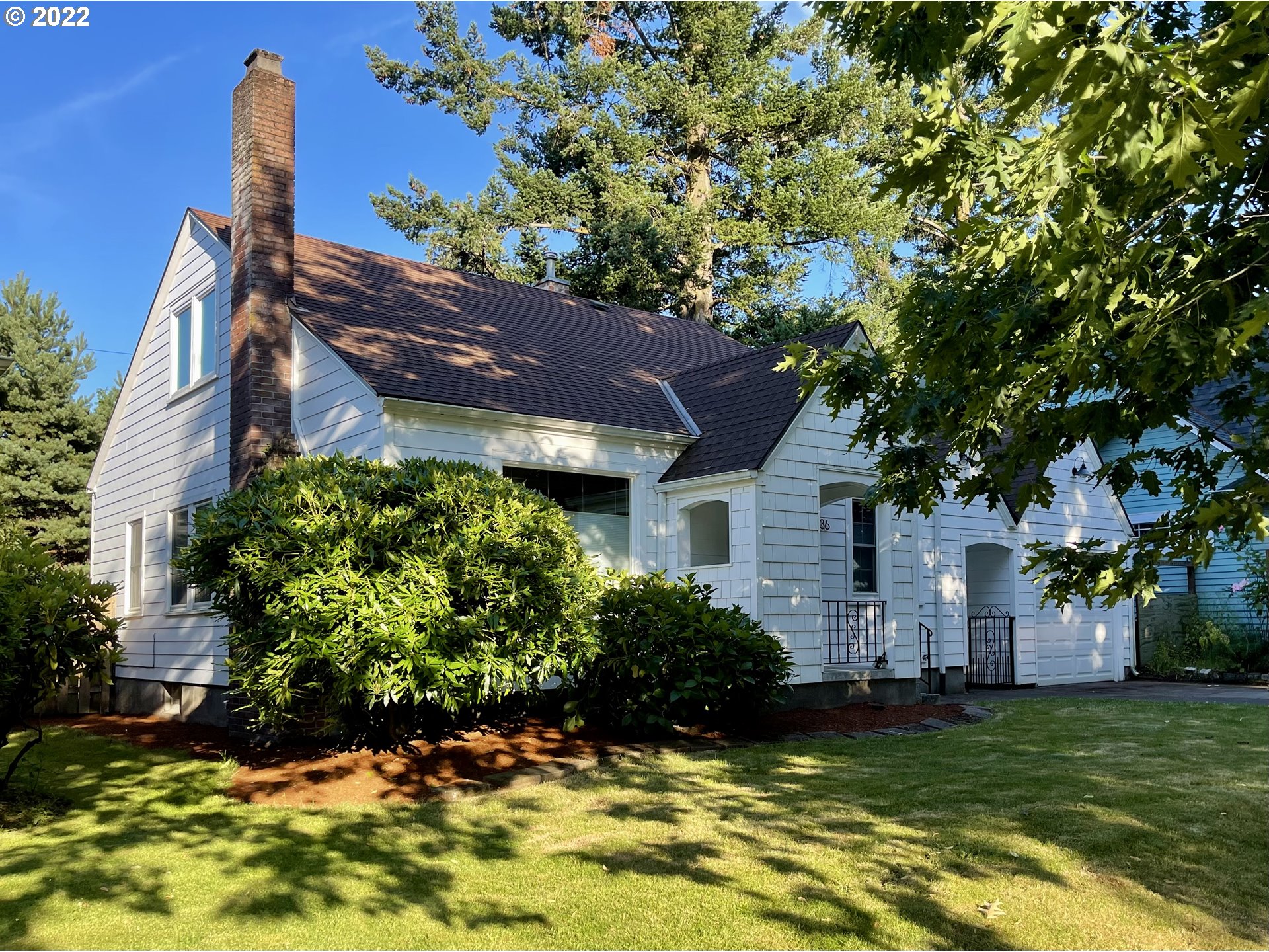 7136 North Chase Avenue Portland, OR 97217 - Photo 1 of 26 a view of a house with a big yard and a large tree