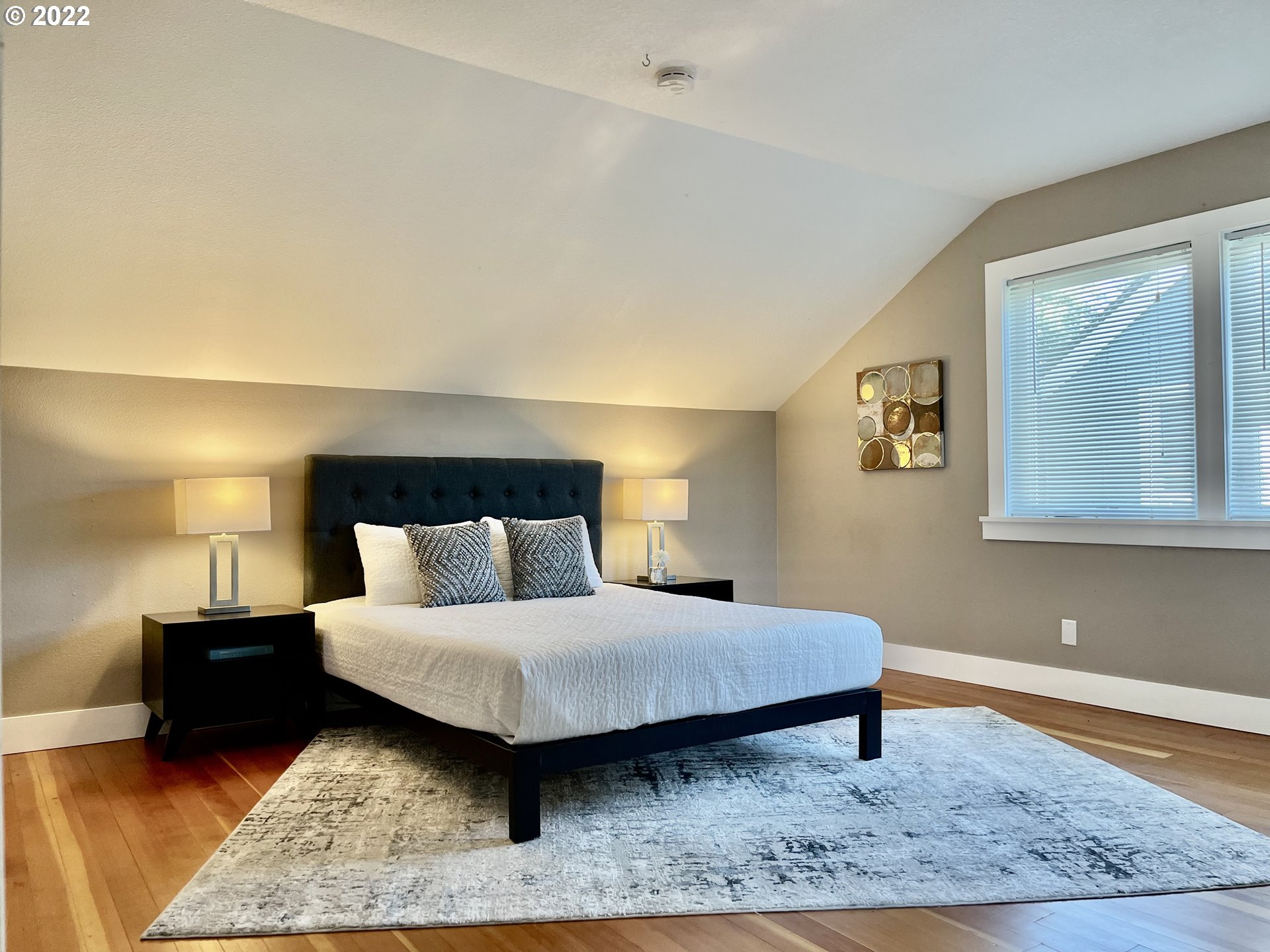 7136 North Chase Avenue Portland, OR 97217 - Photo 12 of 26 a bedroom with a bed and a night stand