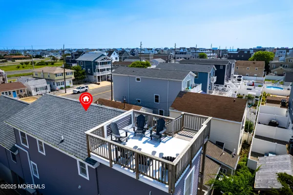 an aerial view of a balcony with chairs