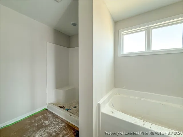 a bathroom with a tub and shower