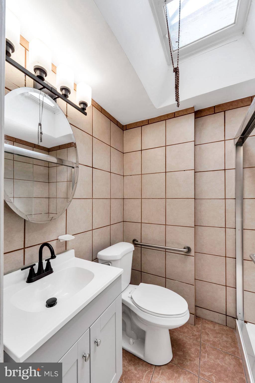 312 Golf Road Darby, PA 19023 - Photo 17 of 27 a bathroom with a sink toilet and mirror
