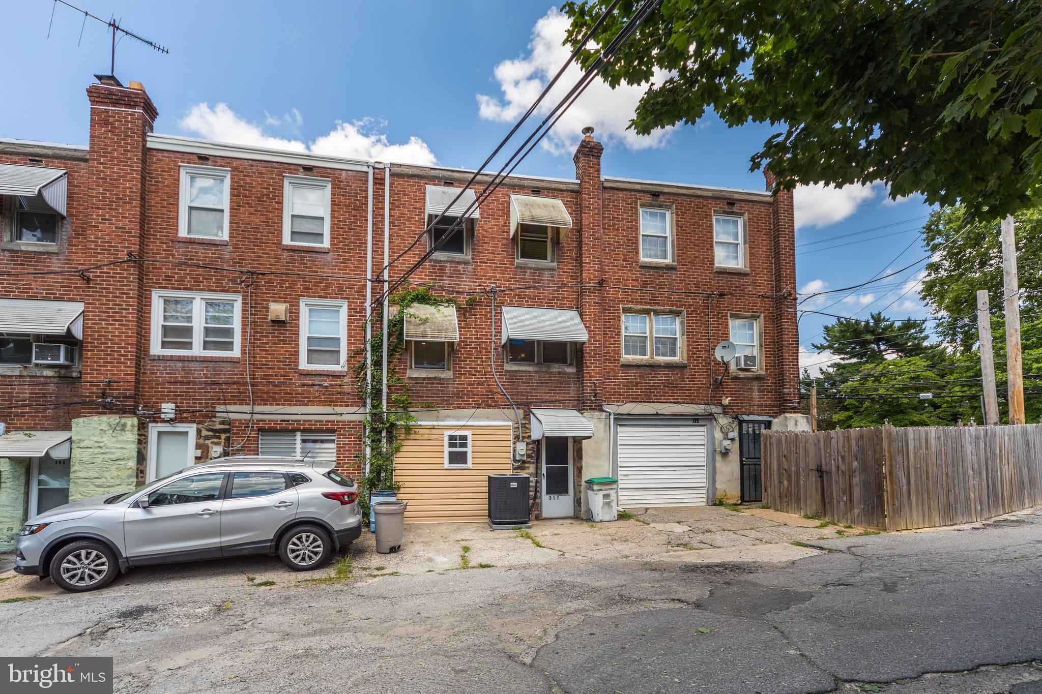 312 Golf Road Darby, PA 19023 - Photo 25 of 27 a front view of a residential apartment building with a yard