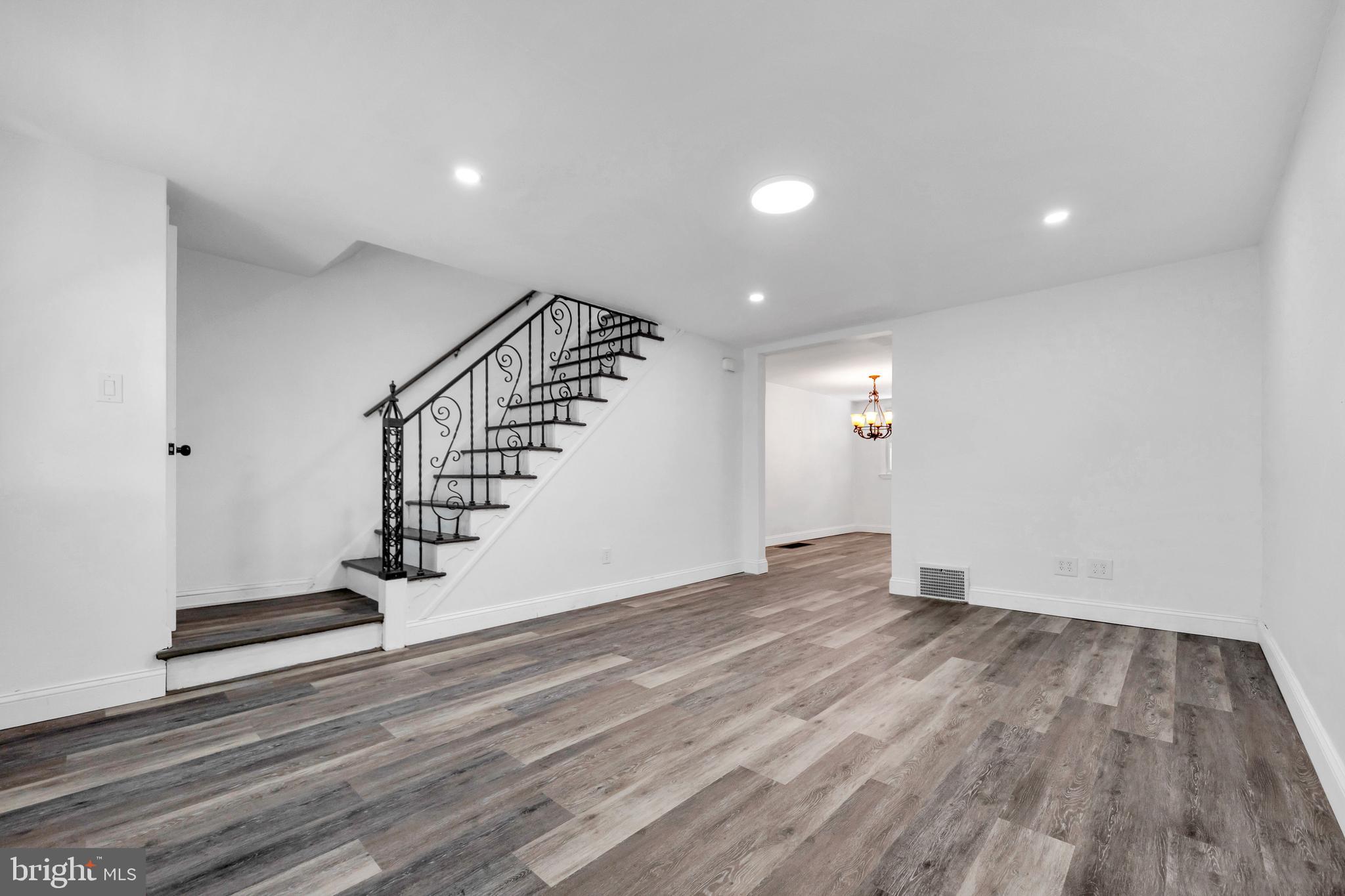 312 Golf Road Darby, PA 19023 - Photo 7 of 27 an empty room with wooden floor and entryway