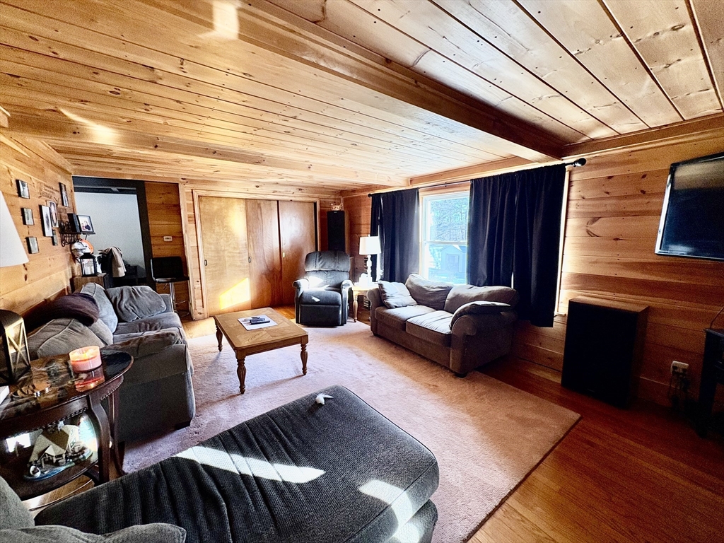 111 Quaboag Street Warren, MA 01083 - Photo 15 of 38 a living room with furniture and a wooden floor