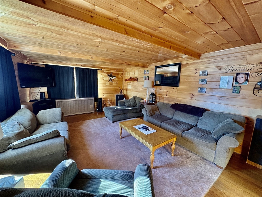 111 Quaboag Street Warren, MA 01083 - Photo 17 of 38 a living room with furniture kitchen view and a wooden floor