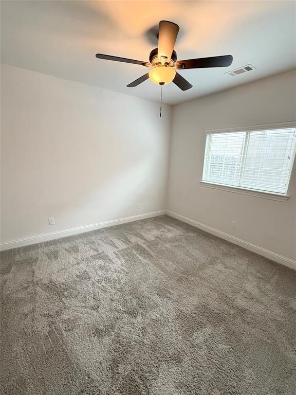 204 Flower Ridge Drive Fort Worth, TX 76108 - Photo 11 of 27 an empty room with a ceiling fan and window