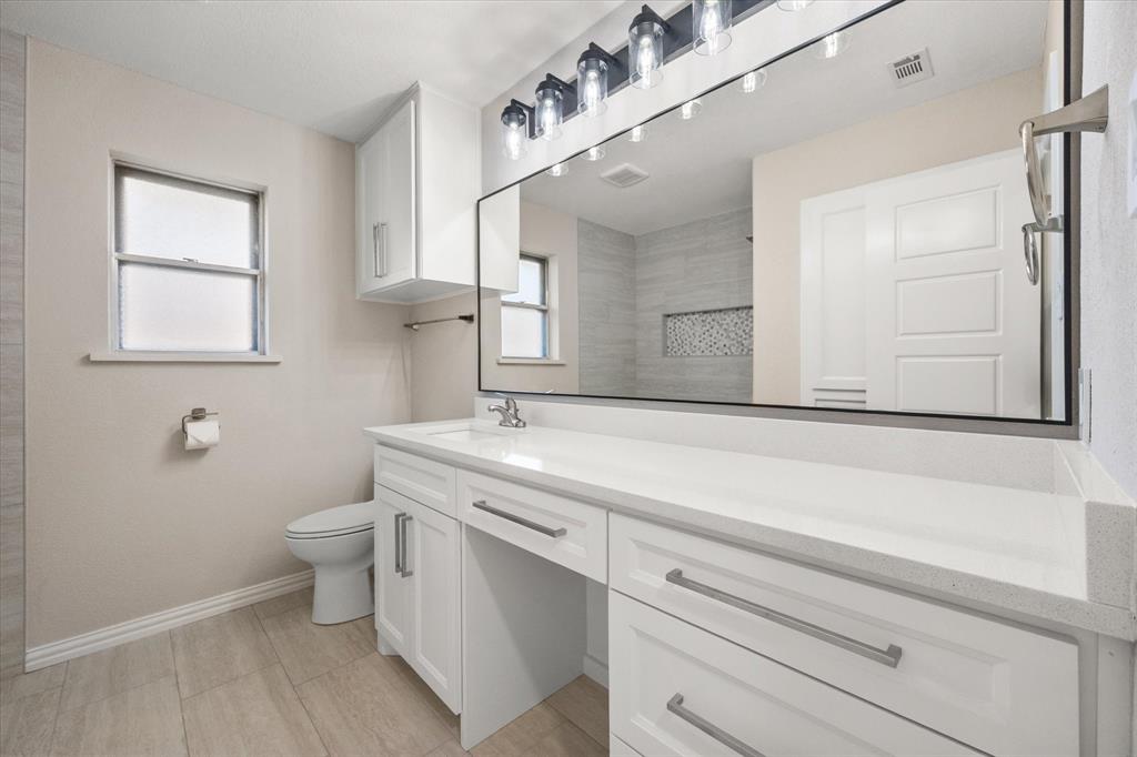 2008 Chalice Road Arlington, TX 76014 - Photo 15 of 28 a bathroom with a toilet sink and mirror