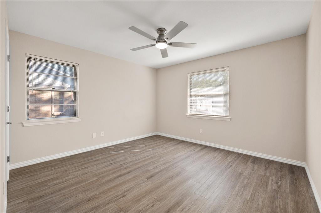 2008 Chalice Road Arlington, TX 76014 - Photo 16 of 28 a view of an empty room with wooden floor and a window