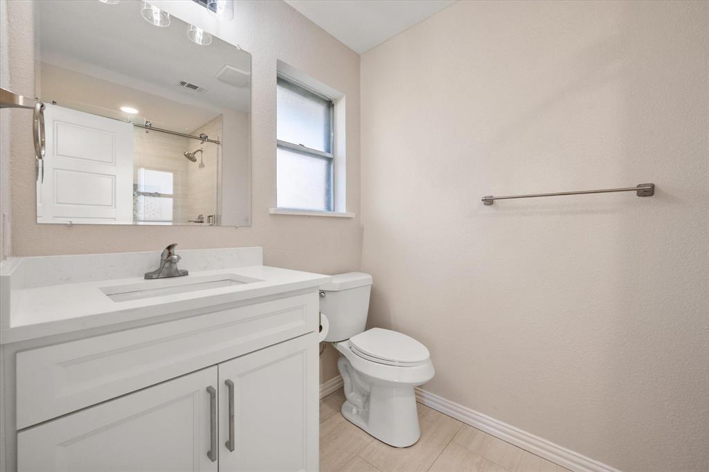 2008 Chalice Road Arlington, TX 76014 - Photo 20 of 28 a bathroom with a sink a toilet and a window