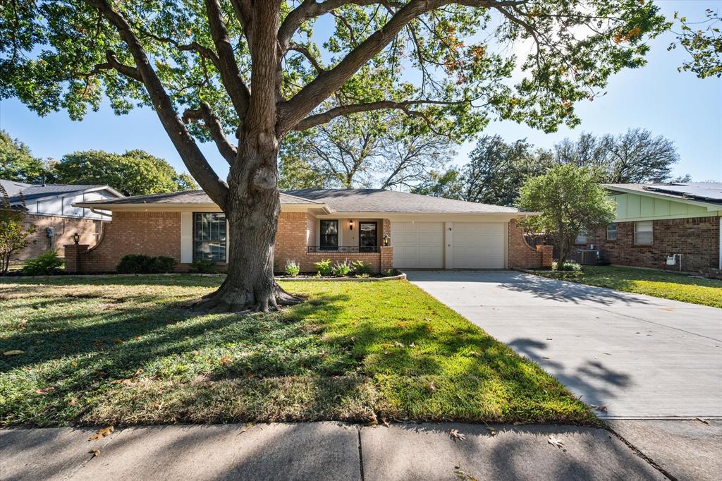 2008 Chalice Road Arlington, TX 76014 - Photo 27 of 28 a front view of a house with a yard and potted plants
