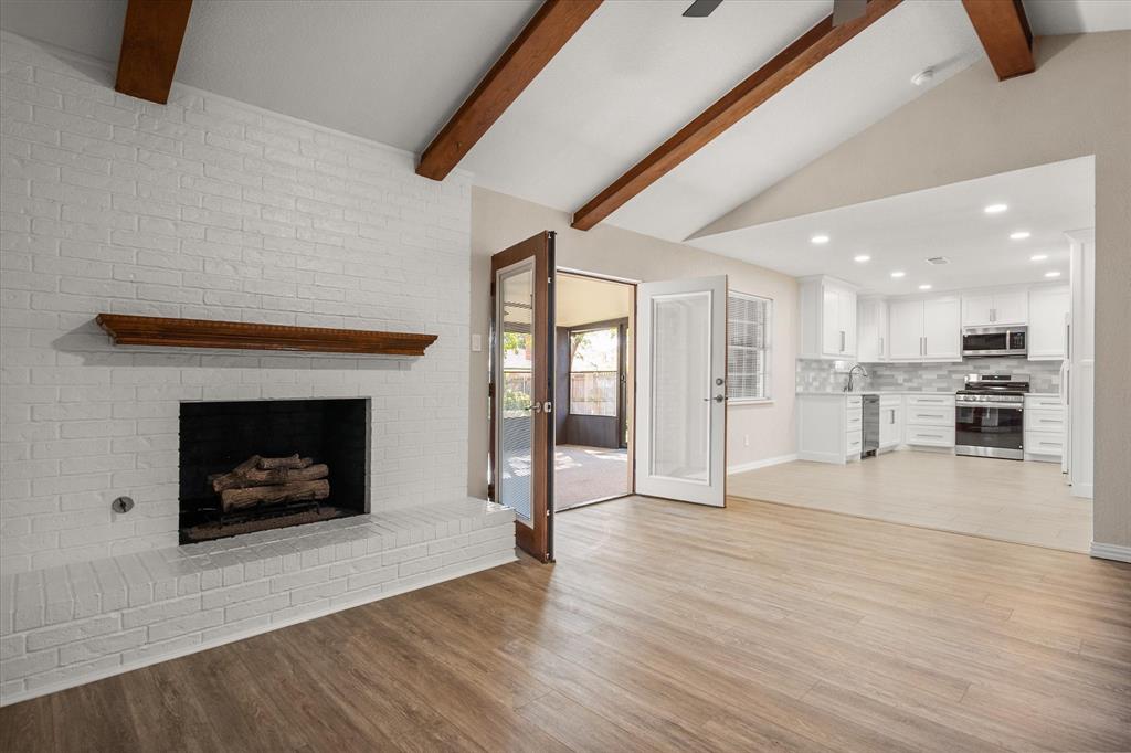 2008 Chalice Road Arlington, TX 76014 - Photo 6 of 28 a view of an empty room with kitchen and fireplace