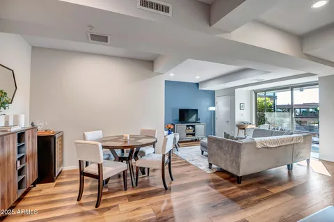 a living room with furniture and a wooden floor