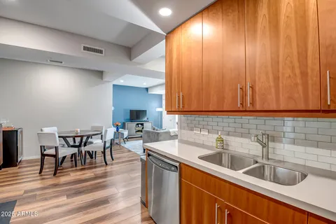 a kitchen with a sink cabinets and dining table chair
