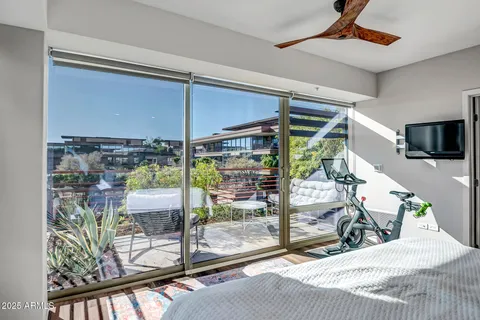 a room with lots of windows and a glass door