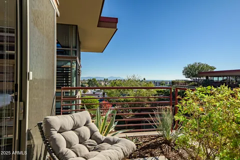 a view of a balcony with couches and wooden floor