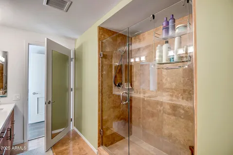 a bathroom with a glass shower door and a bathtub