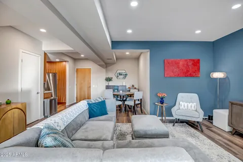a living room with furniture and wooden floor