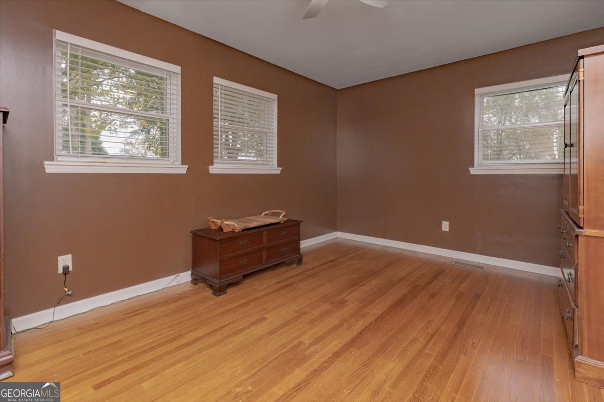 150 Moss Oaks Road Perry, GA 31069 - Photo 33 of 51 a room with wooden floor and windows