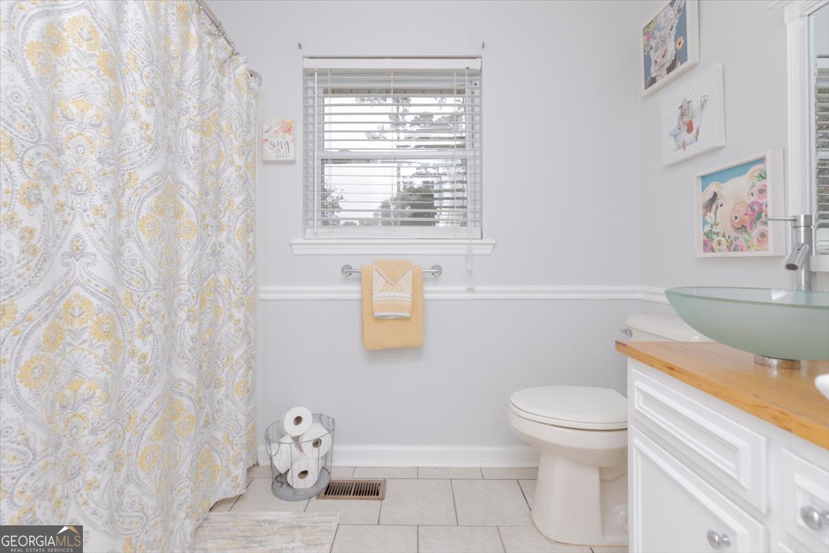150 Moss Oaks Road Perry, GA 31069 - Photo 37 of 51 a bathroom with a toilet a sink and a window