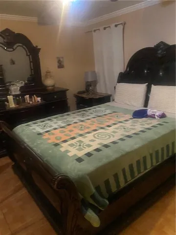 a bedroom with a bed and dresser